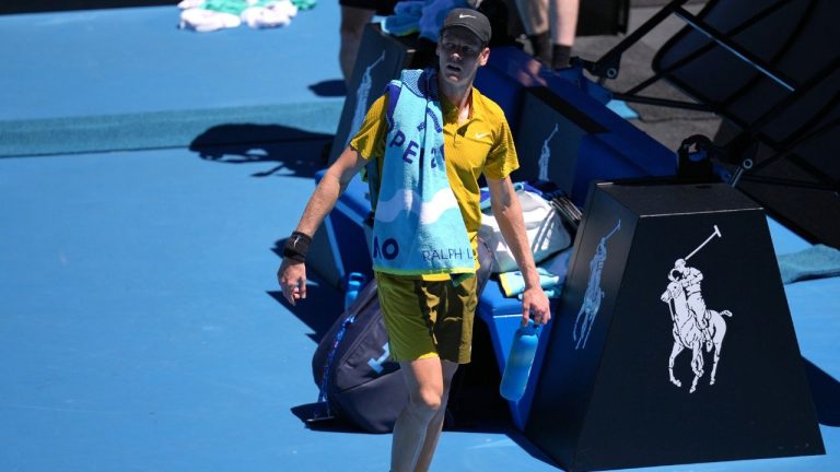 Jannik Sinner of Italy walks from the court as play is halted due to extreme heat during his third round match against Eliot Spizzirri of the U.S. at the Australian Open in Melbourne, Australia, Saturday, Jan. 24, 2026. (AP Photo/Dita Alangkara)