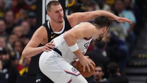 Los Angeles Clippers centre Ivica Zubac, front, is covered by Denver Nuggets centre Nikola Jokić, back, in the first half of an NBA basketball game Friday, Jan. 30, 2026, in Denver. (AP Photo/David Zalubowski)