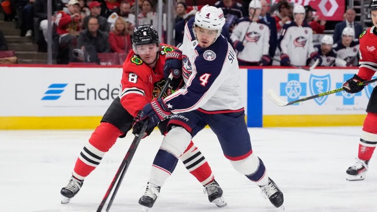 Chicago Blackhawks centre Ryan Donato (8) and Columbus Blue Jackets centre Cole Sillinger (4) battle for the puck during the second period of an NHL hockey game in Chicago, Sunday, Dec.1, 2024. (Nam Y. Huh/AP)
