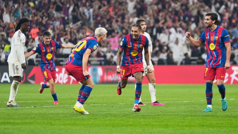 Barcelona's Raphinha, center, celebrates after scoring his second goal during the Spanish Super Cup final soccer match against Real Madrid at King Abdullah Sports City Stadium in Jeddah, Saudi Arabia, Sunday, Jan. 11, 2026. (AP Photo/Altaf Qadri)