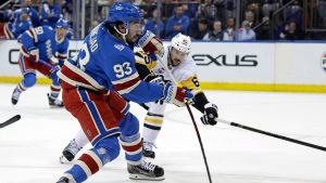New York Rangers centre Mika Zibanejad (93) shoots past Pittsburgh Penguins defenceman Erik Karlsson in the second period of an NHL hockey game Tuesday, Oct. 7, 2025, in New York. (Adam Hunger)