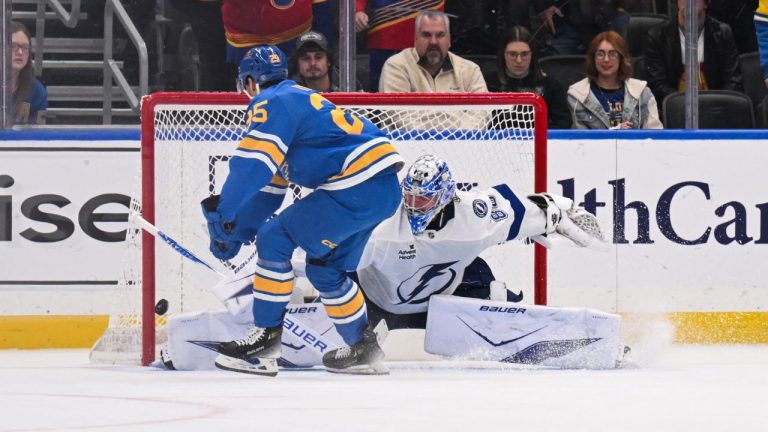St. Louis Blues' Jordan Kyrou, left, scores the winning goal past Tampa Bay Lightning goaltender Andrei Vasilevskiy, right, in a shootout during an NHL hockey game Friday, Jan. 16, 2026, in St. Louis. (AP Photo/Connor Hamilton)
