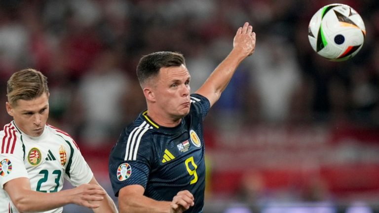 Hungary's Kevin Csoboth, left, and Scotland's Lawrence Shankland, right, challenge for the ball during a Group A match between Scotland and Hungary at the Euro 2024 soccer tournament in Stuttgart, Germany, Sunday, June 23, 2024. (Matthias Schrader/AP)