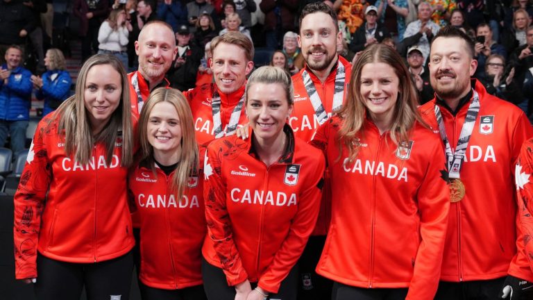 Team Jacobs, rear from left to right, Brad Jacobs, Marc Kennedy, Brett Gallant, and Ben Hebert pose with the winning women's team, from left to right, Rachel Homan, Tracy Fleury, Emma Miskew, and Sarah Wilkes following the Canadian Olympic curling trials in Halifax on Saturday, Nov. 29, 2025. (CP/Darren Calabres)