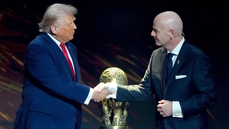 FIFA President Gianni Infantino, right, awards President Donald Trump with the FIFA Peace Prize during the draw for the 2026 soccer World Cup at the Kennedy Center in Washington, Friday, Dec. 5, 2025. (Chris Carlson/AP)