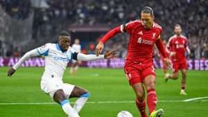 Liverpool's Virgil van Dijk kicks the ball ahead of Marseille's Timothy Weah, left, during the Champions League opening phase soccer match between Marseille and Liverpool in Marseille, France, Wednesday, Jan. 21, 2026. (Philippe Magoni/AP)