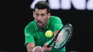 Novak Djokovic of Serbia plays a backhand return to Pedro Martinez of Spain in their first round match at the Australian Open in Melbourne, Australia, Monday, Jan. 19, 2026. (AP Photo/Aaron Favila)