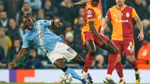 Manchester City's Jeremy Doku, left, is challenged by Galatasaray's Davinson Sanchez during the Champions League opening phase soccer match Manchester City and Galatasaray in Manchester, England, Wednesday, Jan. 28, 2026. (Dave Thompson/AP)
