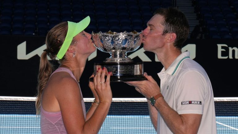 Australia's Olivia Gadecki and John Peers kiss their trophy after defeating France's Kristina Mladenovic and Manuel Guinard in the mixed doubles final at the Australian Open tennis championship in Melbourne, Australia, Friday, Jan. 30, 2026. (Dita Alangkara/AP)
