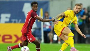 Canada's Ali Ahmed, left, challenges for the ball with Romania's Denis Dragus during an international friendly soccer match between Romania and Canada at the National Arena stadium. (Andreea Alexandru/AP)