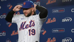 Bo Bichette puts on his hat and jersey during his introductory press conference with the New York Mets, Wednesday, Jan. 21, 2026, in New York. (Heather Khalifa/AP)
