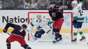 Columbus Blue Jackets centre Charlie Coyle (3) skates in on Vancouver Canucks goaltender Kevin Lankinen (32) in the first period of an NHL hockey game Thursday, Jan. 15, 2026, in Columbus, Ohio. (Sue Ogrocki/AP)