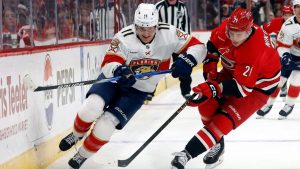 Florida Panthers' MacKie Samoskevich (11) battles Carolina Hurricanes' Alexander Nikishin (21) for the puck during the first period of an NHL hockey game in Raleigh, N.C., Friday, Jan. 16, 2026. (Karl DeBlaker/AP)