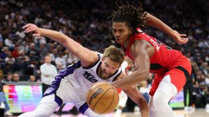 Toronto Raptors forward Collin Murray-Boyles, right, and Sacramento Kings forward Domantas Sabonis, left, battle for the ball during the second half of an NBA basketball preseason game Wednesday, Oct. 8, 2025, in Sacramento, Calif. (Scott Marshall/AP)