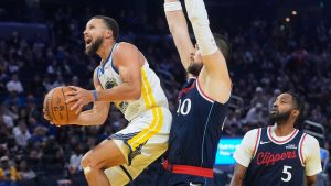 Golden State Warriors guard Stephen Curry, left, shoots against Los Angeles Clippers centre Ivica Zubac, middle, and forward Derrick Jones Jr. (5) during the second half of an NBA basketball game in San Francisco, Tuesday, Oct. 28, 2025. (Jeff Chiu/AP)