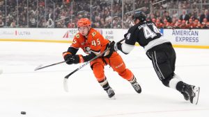 Anaheim Ducks right wing Beckett Sennecke, left, passes the puck while under pressure from Los Angeles Kings defenceman Mikey Anderson during the first period of an NHL hockey game Friday, Jan. 16, 2026, in Los Angeles. (Mark J. Terrill/AP)