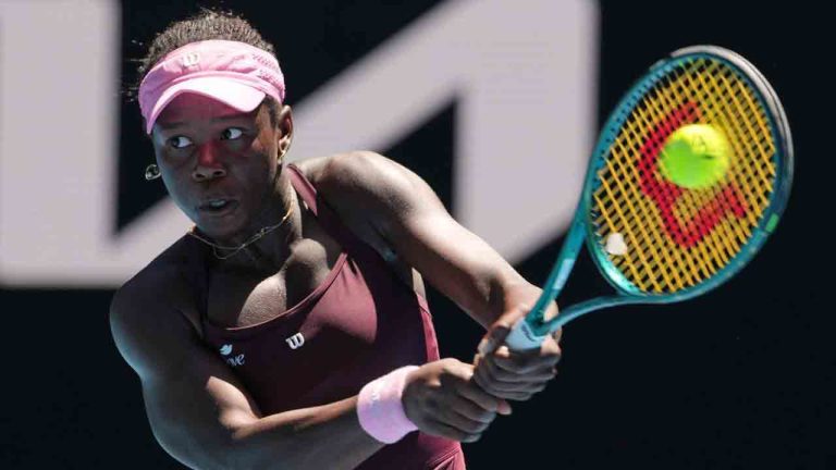 Victoria Mboko of Canada plays a backhand return to Clara Tauson of Denmark during their third round match at the Australian Open tennis championship in Melbourne, Australia, Friday, Jan. 23, 2026. (Aaron Favila/AP)
