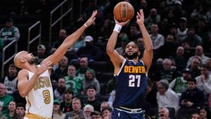 Denver Nuggets guard Jamal Murray (27) shoots against Boston Celtics guard Derrick White (9) during the first half of an NBA basketball game, Wednesday, Jan. 7, 2026, in Boston. (Charles Krupa/AP)