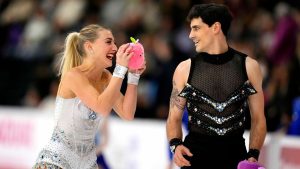 Piper Gilles and Paul Poirier laugh over stuffed toys thrown onto the ice by spectators after their rhythm dance in the senior ice dance figure skating competition at the 2026 Canadian National Skating Championships in Gatineau, Que., on Saturday, Jan. 10, 2026. (Justin Tang/CP)