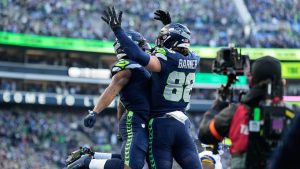 Seattle Seahawks running back Kenneth Walker III, left, celebrates his rushing touchdown with tight end AJ Barner (88) during the first half of the NFC Championship NFL football game against the Los Angeles Rams, Sunday, Jan. 25, 2026, in Seattle. (Stephen Brashear/AP)