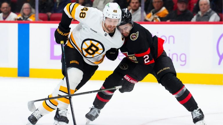 Boston Bruins' Jeffrey Viel (48) moves past Ottawa Senators' Artem Zub (2) during third period NHL hockey action in Ottawa on Thursday, Nov. 13, 2025. (Sean Kilpatrick/CP)