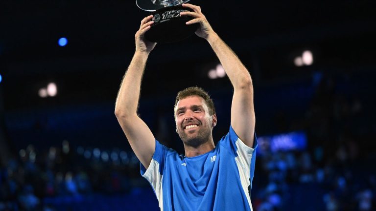 Australia's Jordan Smith holds his trophy aloft after defeating Joanna Garland of Taiwan to win the 1 Point Slam event ahead of the Australian Open in Melbourne, Australia, Wednesday, Jan. 14, 2026. (James Ross/AAP Image via AP)