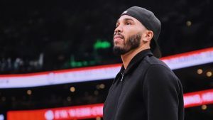 Boston Celtics forward Jayson Tatum, who is out with an injury, stands near the bench during a time out in the first half of an NBA basketball game against the Denver Nuggets, Wednesday, Jan. 7, 2026, in Boston. (Charles Krupa/AP)
