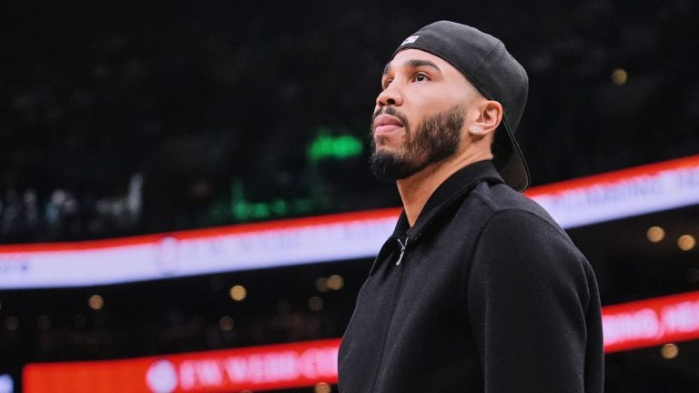 Boston Celtics forward Jayson Tatum, who is out with an injury, stands near the bench during a time out in the first half of an NBA basketball game against the Denver Nuggets, Wednesday, Jan. 7, 2026, in Boston. (Charles Krupa/AP)