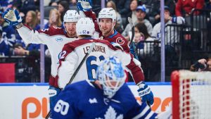 Colorado Avalanche's Brock Nelson (11), right, celebrates with teammates Artturi Lehkonen (62) and Valeri Nichushkin (13) after scoring against the Toronto Maple Leafs during first period NHL hockey action in Toronto, on Sunday, Jan. 25, 2026. (Sammy Kogan/CP)