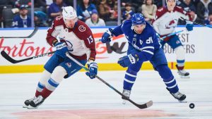 Colorado Avalanche's Valeri Nichushkin (13) and Toronto Maple Leafs' John Tavares (91) battle for the puck during first period NHL hockey action in Toronto, on Sunday, Jan. 25, 2026. (Sammy Kogan/CP)