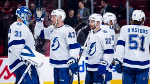 Tampa Bay Lightning goaltender Jonas Johansson (31), Darren Raddysh (43) and Oliver Bjorkstrand (22) celebrate with teammates after defeating the Montreal Canadiens in NHL hockey action in Montreal on Tuesday, Dec. 9, 2025. (Christopher Katsarov/CP)