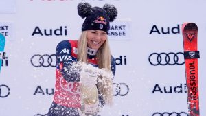 United States' Lindsey Vonn sprays sparkling wine as she celebrates on podium after winning an alpine ski, women's World Cup downhill, in Zauchensee, Austria, Saturday, Jan. 10, 2026. (Giovanni Auletta/AP)
