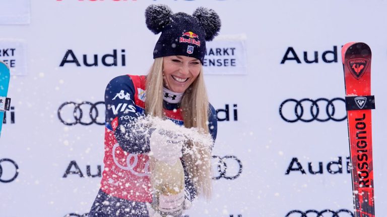 United States' Lindsey Vonn sprays sparkling wine as she celebrates on podium after winning an alpine ski, women's World Cup downhill, in Zauchensee, Austria, Saturday, Jan. 10, 2026. (Giovanni Auletta/AP)