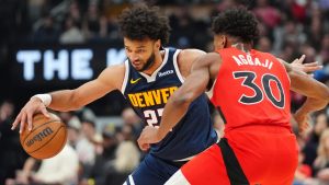 Denver Nuggets guard Jamal Murray (27) tries to get around Toronto Raptors guard Ochai Agbaji (30) during first half NBA action in Toronto on Wednesday December 31, 2025. (Frank Gunn/CP)