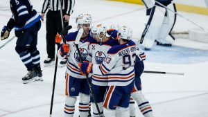 Edmonton Oilers players celebrate Evan Bouchard's (2) goal against the Winnipeg Jets during third period NHL action in Winnipeg, Thursday, January 8, 2026. (John Woods/CP)
