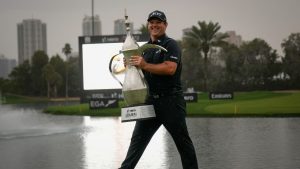 Patrick Reed of the United States walks while holding the Dubai Desert Classic trophy after winning it in Dubai, United Arab Emirates, Sunday, Jan. 25, 2026. (Altaf Qadri/AP)