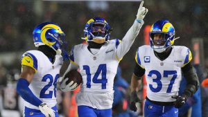 Los Angeles Rams cornerback Cobie Durant (14) reacts with safety Kamren Kinchens (26) and safety Quentin Lake (37) after intercepting a pass by Chicago Bears quarterback Caleb Williams, not visible, during the second half of an NFL football divisional playoff game Sunday, Jan. 18, 2026, in Chicago. (Nam Y. Huh/AP)