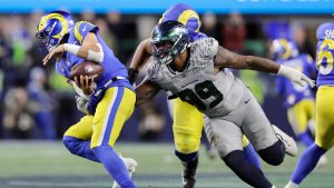 Los Angeles Rams quarterback Matthew Stafford (9) scrambles to avoid Seattle Seahawks defensive end Leonard Williams (99) in an NFL football game, Thursday, Dec. 18, 2025, in Seattle. (John Froschauer/AP)