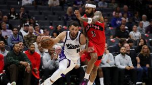 Sacramento Kings guard Zach LaVine (8) dribbles by Toronto Raptors forward Brandon Ingram (3) during the first half of an NBA basketball preseason game Wednesday, Oct. 8, 2025, in Sacramento, Calif. (Scott Marshall/AP)