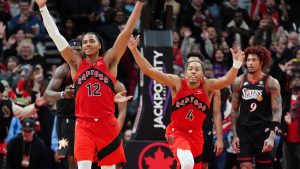 Toronto Raptors forward Collin Murray-Boyles (12) and teammate Scottie Barnes (4) celebrate the team's win at the end of overtime NBA basketball action against the Philadelphia 76ers, in Toronto, Sunday, Jan. 11, 2026. (Frank Gunn/CP)