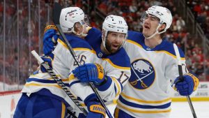 Buffalo Sabres' Rasmus Dahlin (26) celebrates his goal with teammates Jason Zucker (17) and Ryan McLeod (71) during the first period of an NHL hockey game against the Carolina Hurricanes in Raleigh, N.C., Monday, Jan. 19, 2026. (Karl DeBlaker/AP)