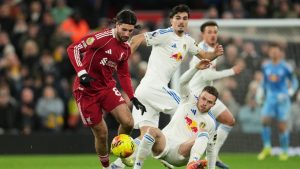 Liverpool's Dominik Szoboszlai, left, and Leeds' Gabriel Gudmundsson challenge for the ball during the English Premier League soccer match between Liverpool and Leeds United in Liverpool, England, Thursday, Jan. 1, 2026. (Jon Super/AP)