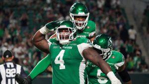 Saskatchewan Roughriders defensive lineman Micah Johnson (4) celebrates with teammates during the second half of CFL football action in Regina, on Friday, July 25, 2025. (Heywood Yu/CP)