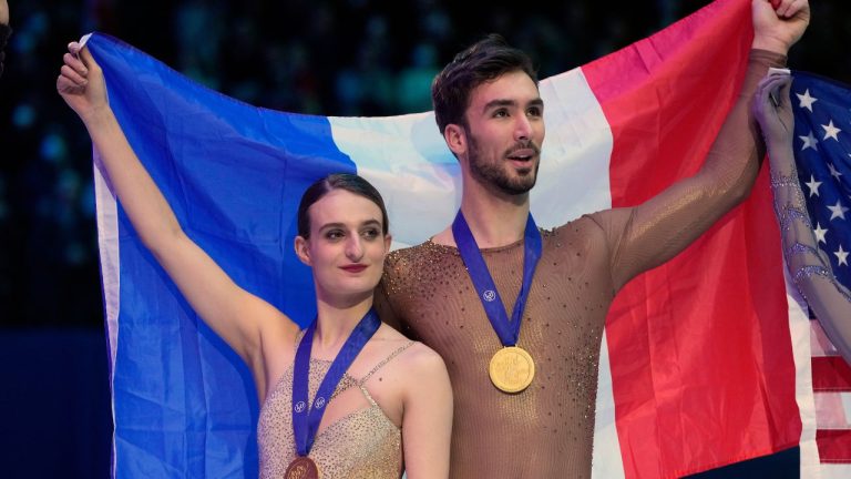 Gabriella Papadakis and Guillaume Cizeron of France celebrate their gold medal during the Ice Dance victory ceremony at the Figure Skating World Championships in Montpellier, south of France, Saturday, March 26, 2022. (Francisco Seco/AP Photo)