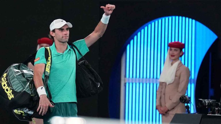Eliot Spizzirri of the U.S. waves as he leaves the court following his third round loss to Jannik Sinner of Italy at the Australian Open tennis championship in Melbourne. (Dita Alangkara/AP)