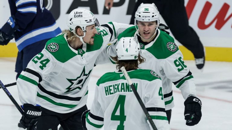 Dallas Stars' Roope Hintz (24), Miro Heiskanen (4) and Mikko Rantanen (96) celebrate Rantanen's goal against the Winnipeg Jets during first period NHL action in Winnipeg on Thursday, October 9, 2025. (John Woods/CP)
