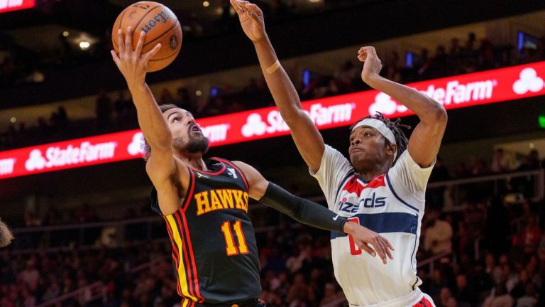 Atlanta Hawks guard Trae Young (11) goes up for a layup while guarded by Washington Wizards guard Bilal Coulibaly, right, during the first half of an Emirates NBA Cup basketball game, Friday, Nov. 15, 2024, in Atlanta. (Jason Allen/AP)