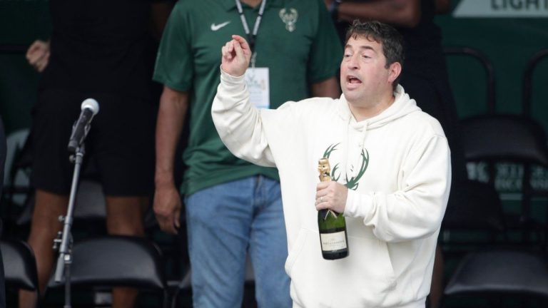Milwaukee Bucks president Peter Feigin holds a bottle of champagne during a parade celebrating the Milwaukee Bucks' NBA Championship basketball team July 22, 2021, in Milwaukee. (Aaron Gash/AP)