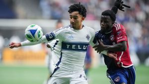 Vancouver Whitecaps' Rayan Elloumi, left, and FC Dallas' Lalas Abubakar vie for the ball during the second half in Game 1 of a first round MLS Cup playoff soccer match, in Vancouver, B.C., Sunday, Oct. 26, 2025. (Darryl Dyck/THE CANADIAN PRESS)
