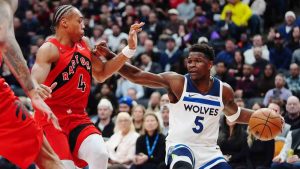 Minnesota Timberwolves' Anthony Edwards (5) protects the ball from Toronto Raptors' Scottie Barnes (4) during first half NBA basketball action in Toronto on Wednesday, Feb. 4, 2026. (Frank Gunn/CP)